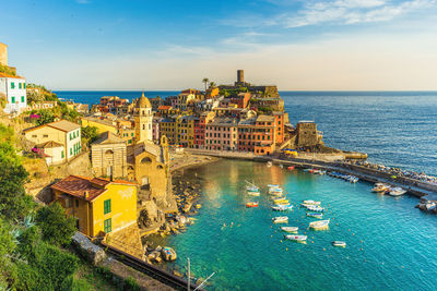 High angle view of buildings by sea against sky