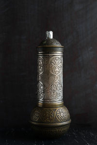 Close-up of old lamp on table