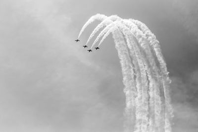 Low angle view of airplane flying against sky