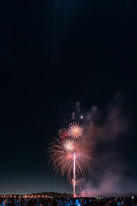 Low angle view of firework display at night