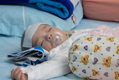 Cute baby lying on bed at home