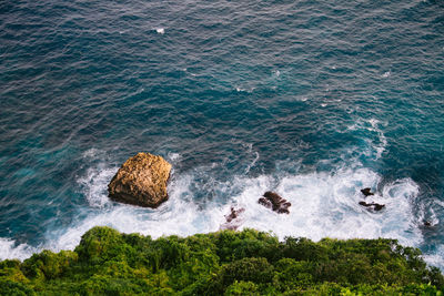 High angle view of rocks in sea