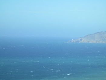 Scenic view of sea against clear blue sky