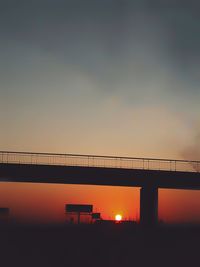 Silhouette of suspension bridge during sunset