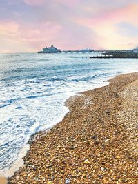 Scenic view of beach against sky during sunset