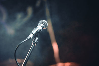 Close-up of microphone against black background