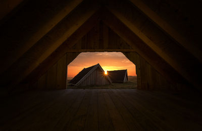 View of houses on field against during sunset