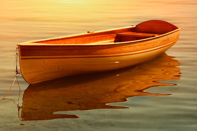 Close-up of boat moored at beach