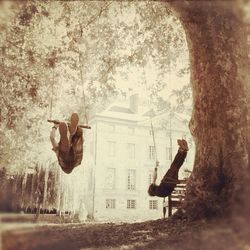 Woman standing on tree trunk