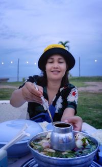 Portrait of woman sitting on table