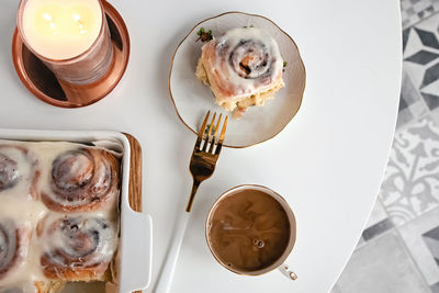 Homemade cinnamon rolls and coffee. breakfast still life with vintage style tableware.