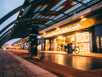 People in illuminated city at night