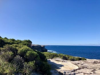 Scenic view of sea against clear blue sky