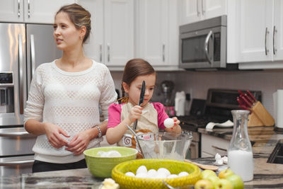 Siblings standing on table at home