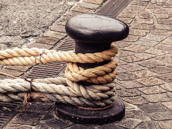 Close-up of rope tied to bollard