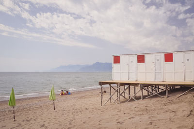 Lifeguard hut on beach against sky