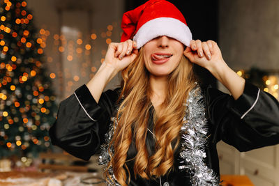 Happy funny girl fooling celebrate christmas holidays and new year in a cozy house