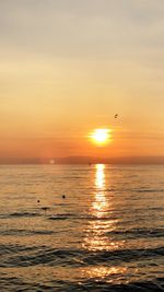 Scenic view of sea against orange sky