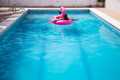 High angle view of woman swimming in pool