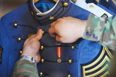 Midsection of woman holding navigational compass