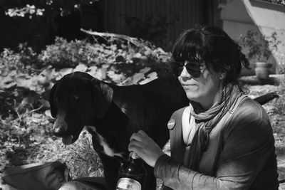 Woman wearing sunglasses with dog