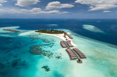 Aerial view of sea against blue sky