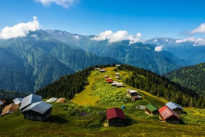 Houses on mountains against sky