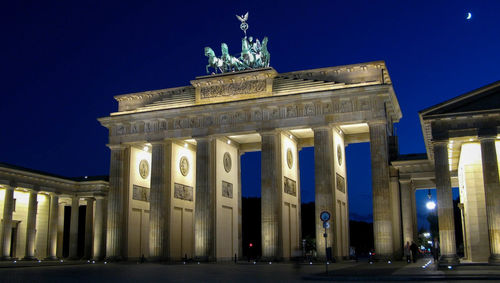 Low angle view of illuminated building at night