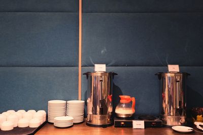 Close-up of bottles on table against wall