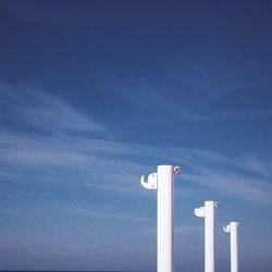 Low angle view of pole against blue sky