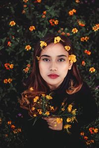 Portrait of young woman with flowers