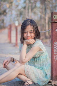 Portrait of smiling woman sitting outdoors