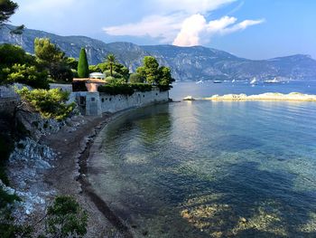 Scenic view of lake by building against sky