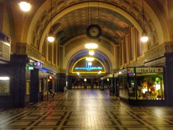 Illuminated underground walkway at night