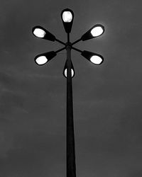 Low angle view of illuminated lamp against sky