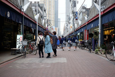 People on footpath in city