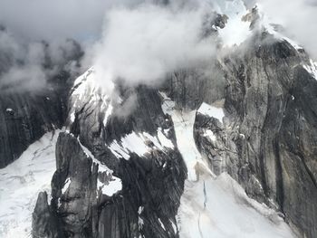 Scenic view of snow covered mountains against sky