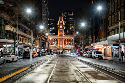 Illuminated city street at night