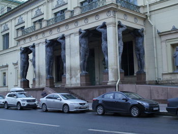 Cars on street against buildings in city