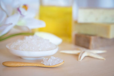 Close-up of salt and starfish on table at spa