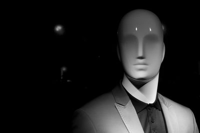 Close-up of mannequin against black background