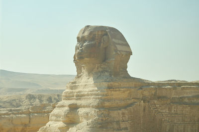 Low angle view of rock formations against clear sky