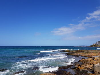 Scenic view of sea against blue sky