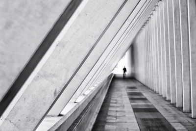 Rear view of woman walking on bridge