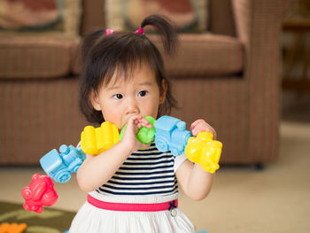 Portrait of cute girl with toys