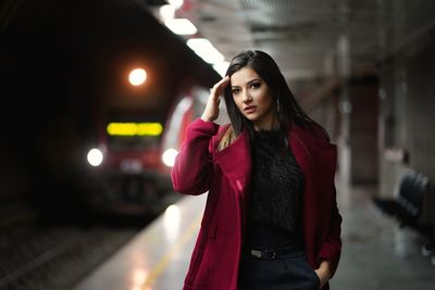 Portrait of beautiful woman standing at railway station