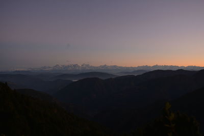 Scenic view of silhouette mountains against sky during sunset