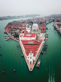 Townscape by sea against clear sky