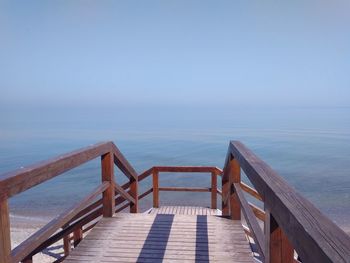 Pier over sea against clear sky