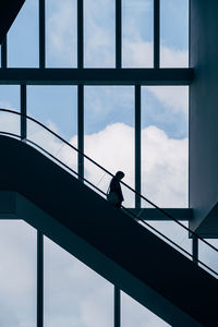 Low angle view of silhouette bridge against sky